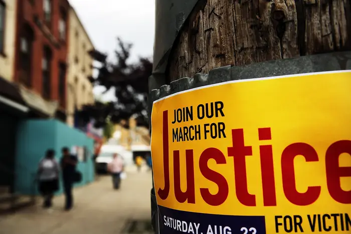 A poster for a protest is viewed near where Eric Garner was killed